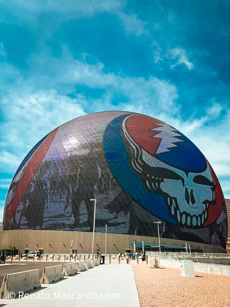 The Sphere in Las Vegas featuring a Grateful Dead-inspired design on its LED exterior, with a clear blue sky above.